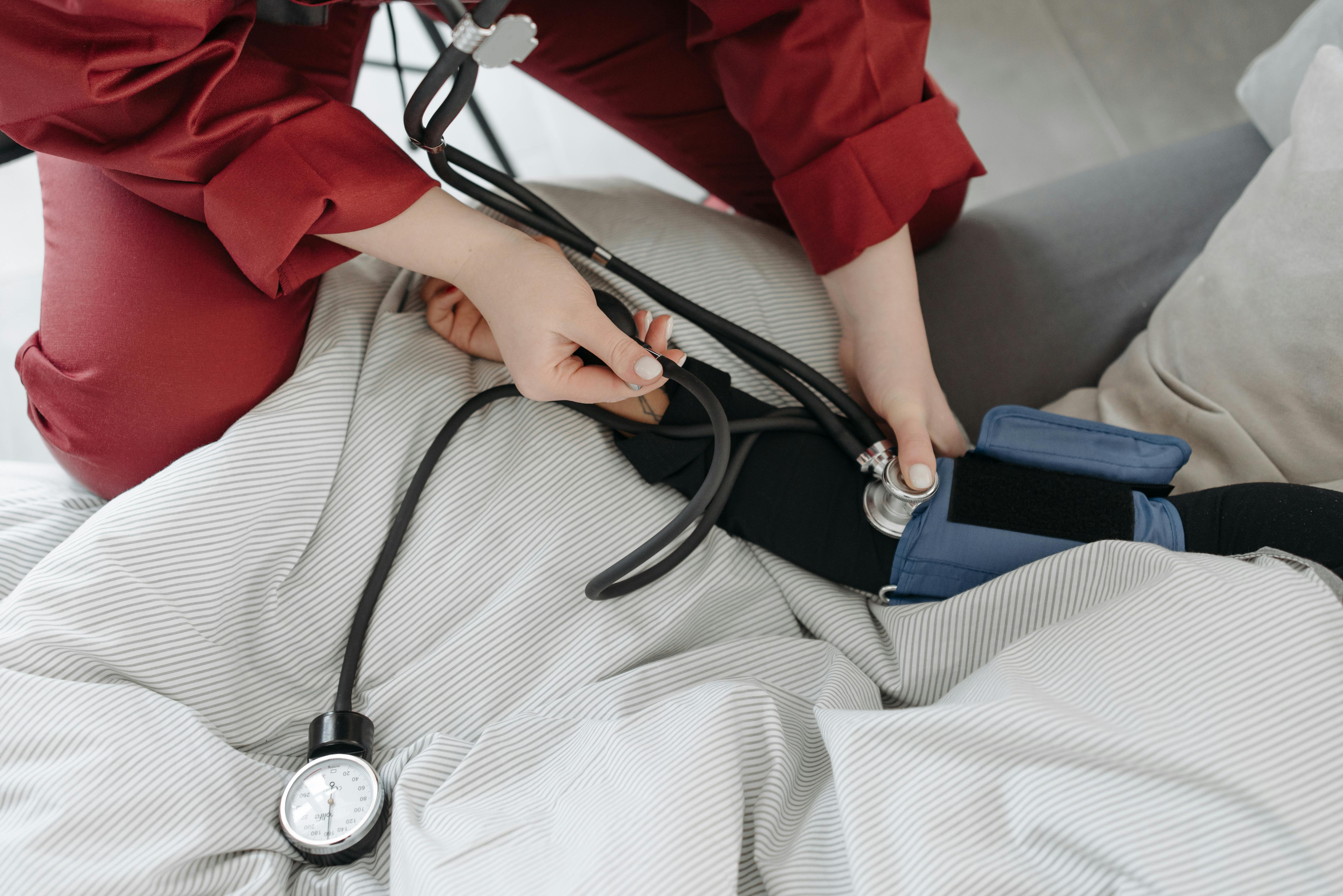 Nurse checking patient at home